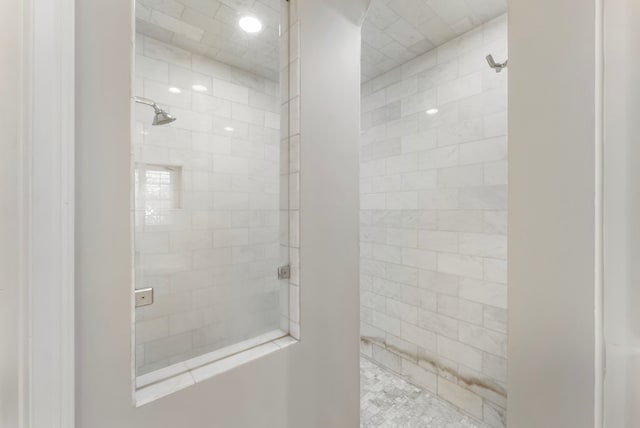 full bath featuring tiled shower