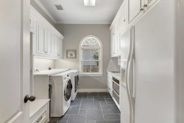 clothes washing area featuring visible vents, washer and dryer, cabinet space, crown molding, and baseboards