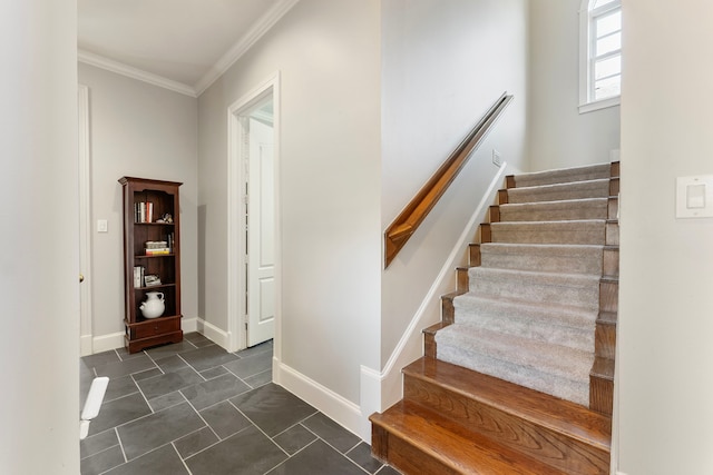 stairs featuring crown molding and baseboards