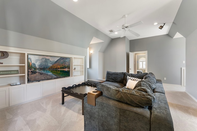 living area featuring built in features, baseboards, lofted ceiling, ceiling fan, and light carpet