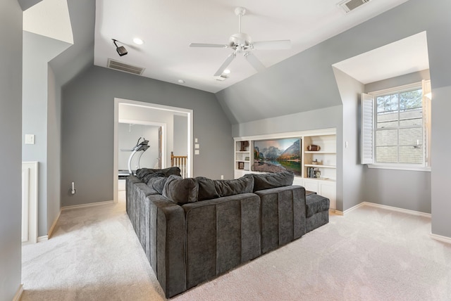 living area with lofted ceiling, baseboards, visible vents, and light carpet