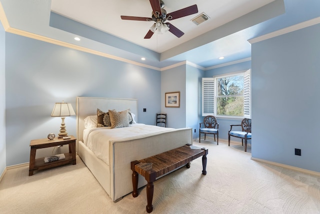 bedroom with visible vents, baseboards, a tray ceiling, ornamental molding, and light carpet