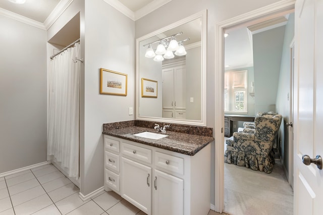 bathroom with vanity, tile patterned floors, baseboards, and ornamental molding