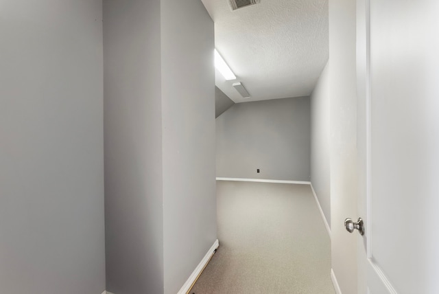 bonus room featuring visible vents, a textured ceiling, baseboards, and carpet floors