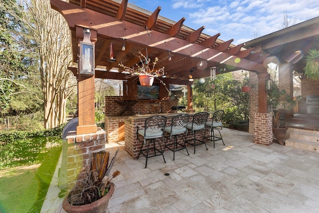 view of patio / terrace featuring outdoor dry bar and a pergola