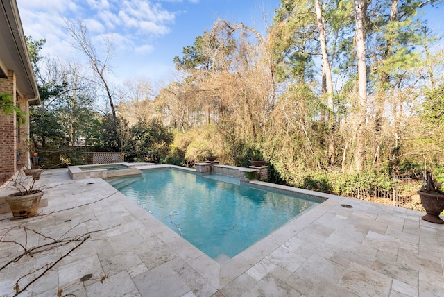 view of pool featuring a patio area and a pool with connected hot tub