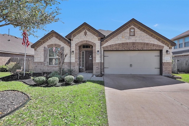 french country inspired facade featuring a front yard, fence, an attached garage, concrete driveway, and brick siding