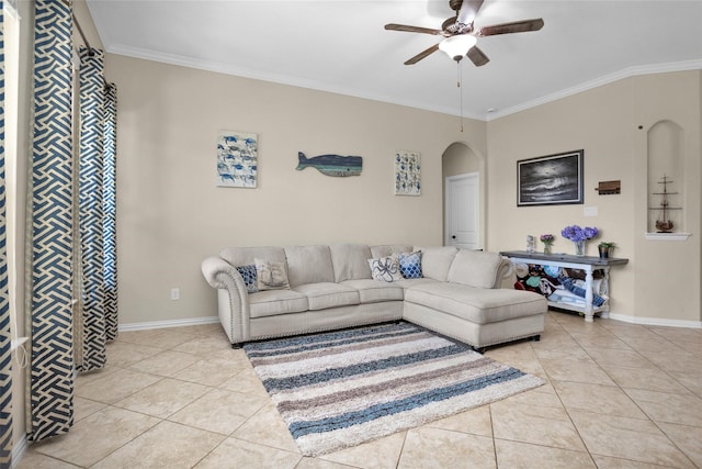 living room with arched walkways, a ceiling fan, light tile patterned flooring, and crown molding