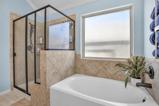 bathroom featuring a shower stall, crown molding, and a garden tub