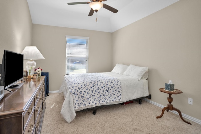 bedroom featuring baseboards, light colored carpet, and ceiling fan