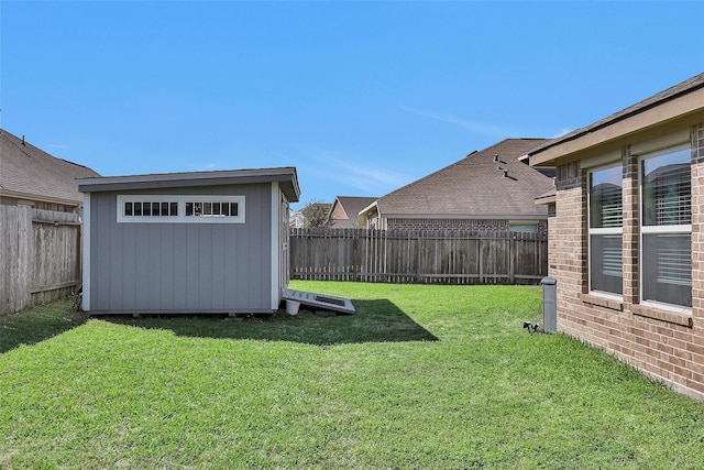 view of yard featuring an outdoor structure, a storage shed, and a fenced backyard