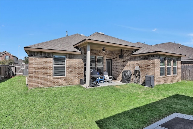 back of house with a patio, a ceiling fan, a fenced backyard, a lawn, and brick siding