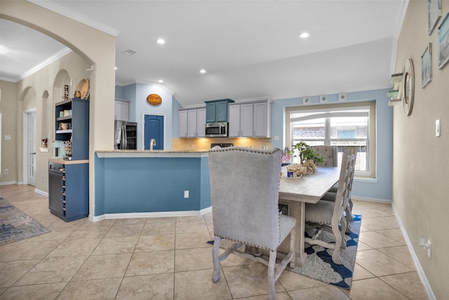 dining room with light tile patterned floors, baseboards, ornamental molding, and recessed lighting