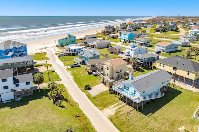 drone / aerial view with a view of the beach, a residential view, and a water view