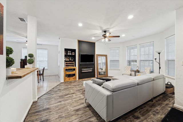 living area featuring recessed lighting, wood finished floors, visible vents, and ceiling fan