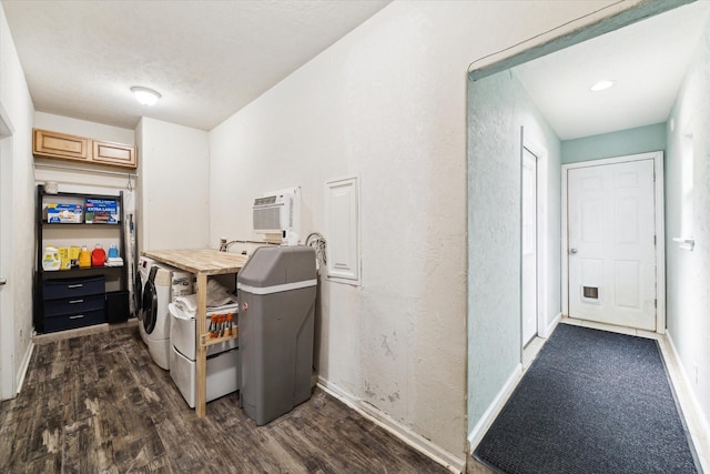 washroom featuring a wall mounted air conditioner, dark wood finished floors, separate washer and dryer, baseboards, and laundry area