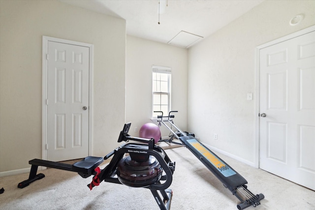 exercise room featuring baseboards and carpet