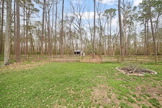 view of yard featuring an outbuilding and fence