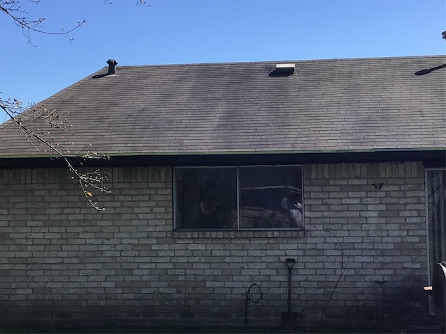 view of side of property featuring brick siding