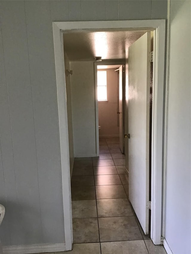 corridor featuring light tile patterned floors