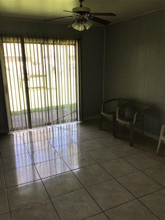 empty room featuring a ceiling fan and tile patterned flooring