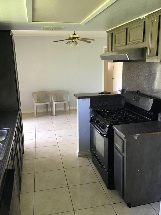 kitchen featuring light tile patterned floors, a ceiling fan, decorative backsplash, black range with gas cooktop, and under cabinet range hood