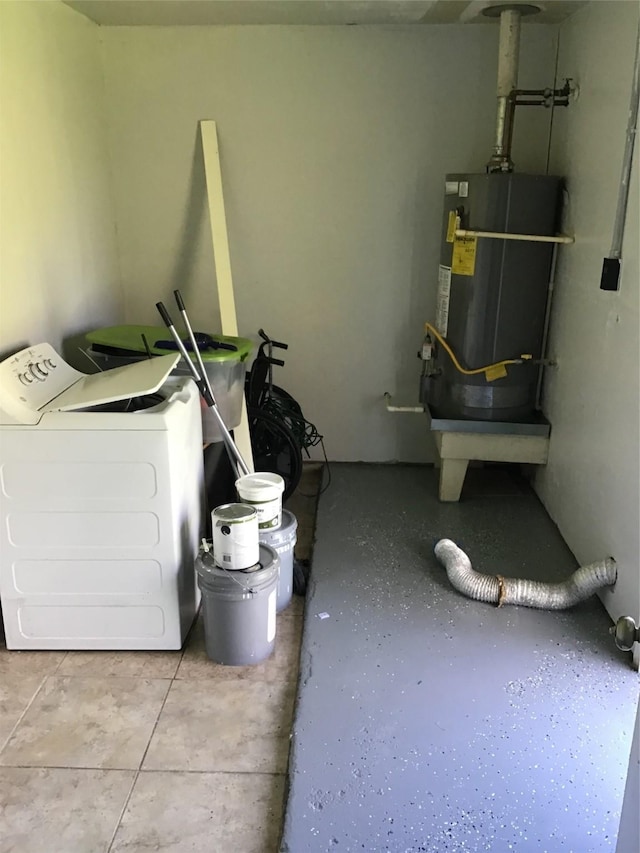 washroom featuring washer / dryer, water heater, and laundry area