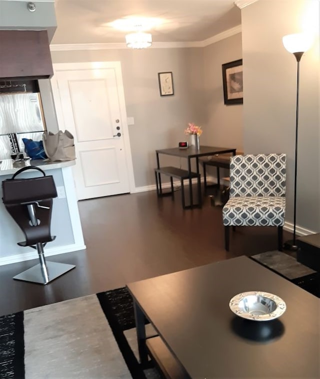 living area with dark wood-style floors, baseboards, and ornamental molding