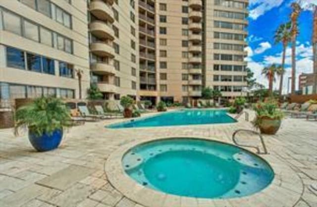 view of pool featuring a patio and a community hot tub