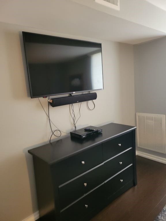 details featuring visible vents, baseboards, and wood finished floors