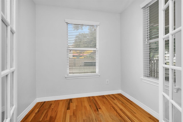 empty room with wood finished floors and baseboards