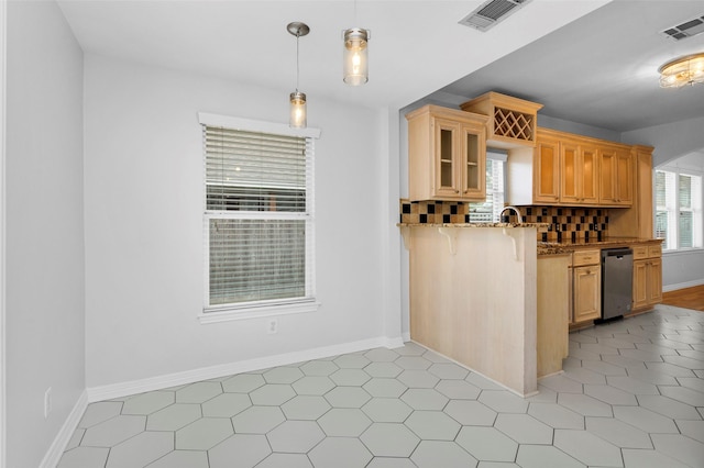 kitchen with hanging light fixtures, visible vents, light stone countertops, and stainless steel dishwasher