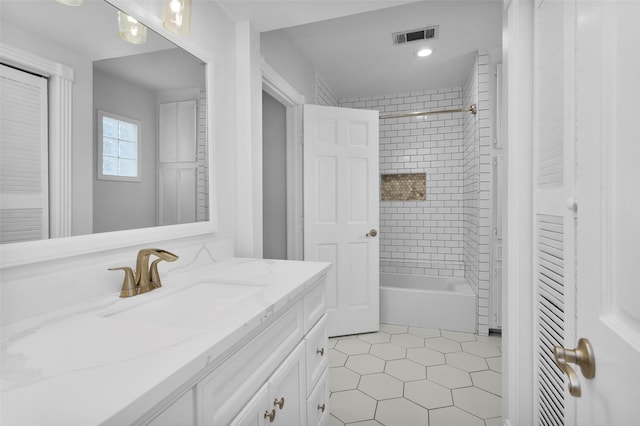 bathroom featuring visible vents, shower / bathtub combination, vanity, and tile patterned flooring