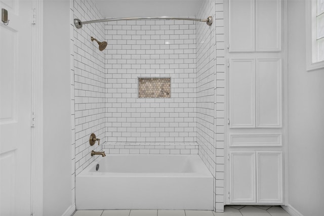 bathroom with tile patterned flooring, bathing tub / shower combination, and baseboards