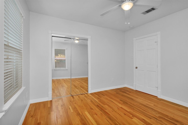 unfurnished bedroom featuring a closet, visible vents, baseboards, and light wood-style floors