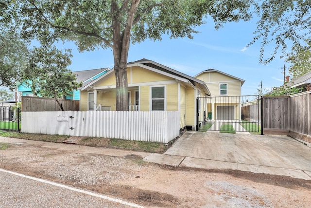 bungalow-style house featuring a fenced front yard and a gate