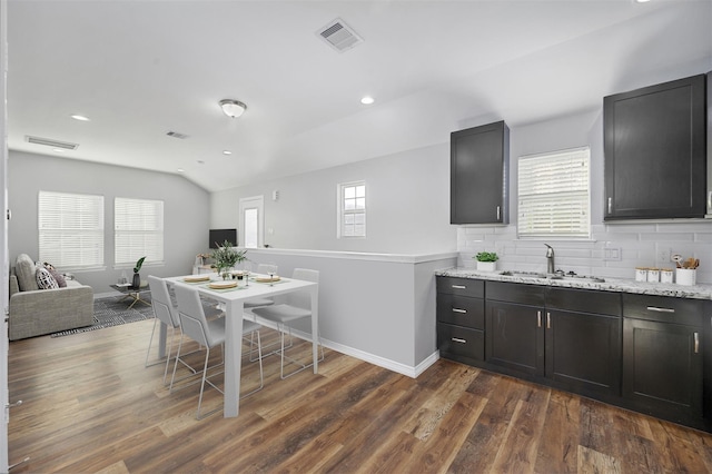 kitchen featuring a sink, visible vents, dark wood-type flooring, and a healthy amount of sunlight