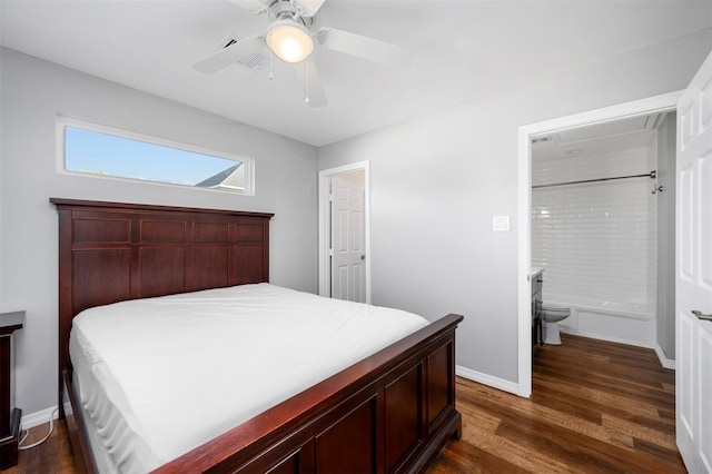 bedroom featuring a ceiling fan, dark wood-style floors, baseboards, and connected bathroom