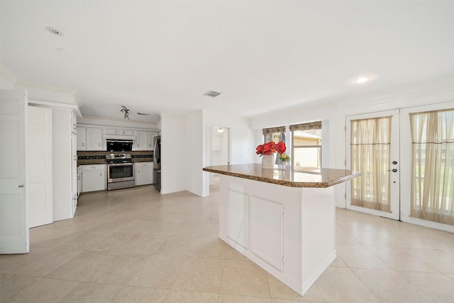 kitchen featuring visible vents, a kitchen island, white cabinets, french doors, and appliances with stainless steel finishes