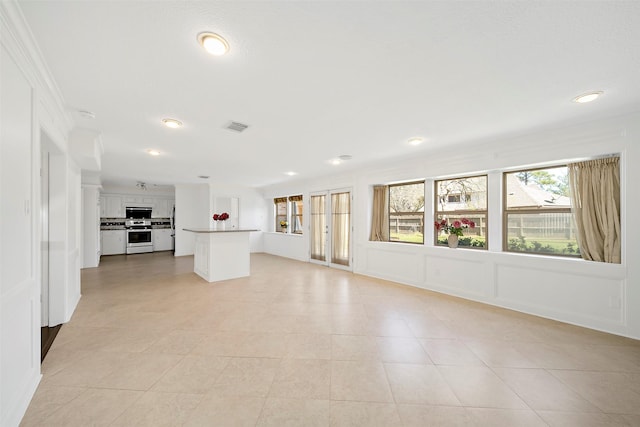 unfurnished living room with light tile patterned flooring, visible vents, and recessed lighting