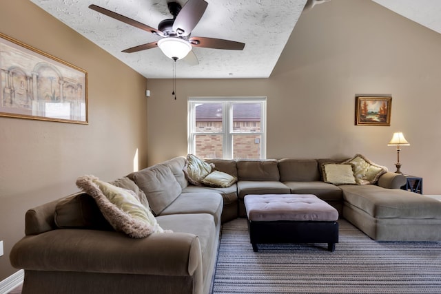 living room featuring a textured ceiling, a ceiling fan, and vaulted ceiling