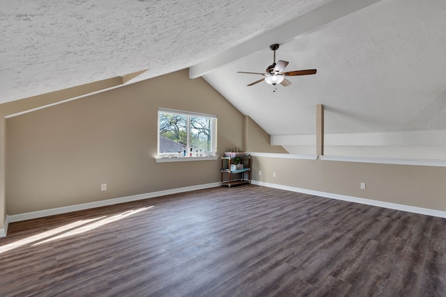 bonus room featuring baseboards, dark wood finished floors, lofted ceiling with beams, ceiling fan, and a textured ceiling