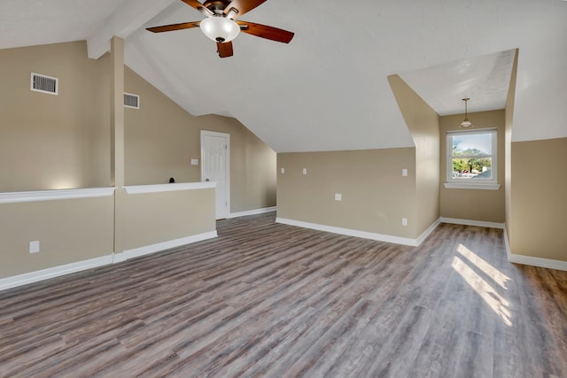 additional living space with lofted ceiling with beams, visible vents, baseboards, and wood finished floors