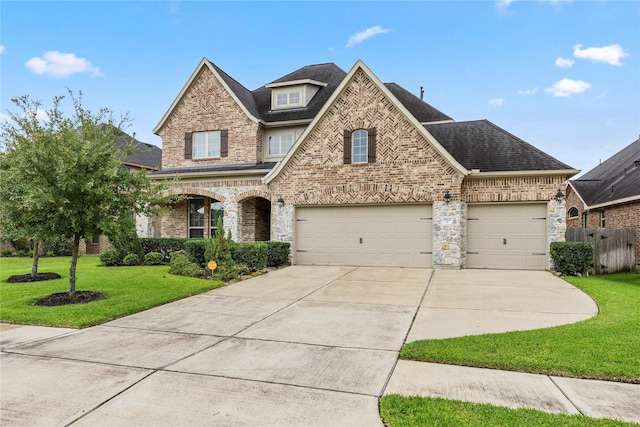 view of front of home with driveway, brick siding, roof with shingles, and a front lawn