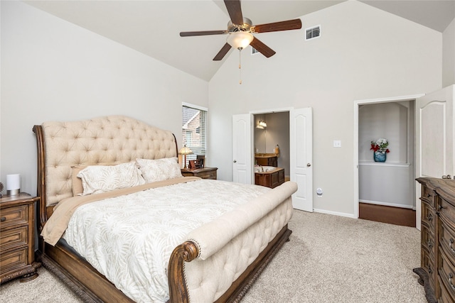 bedroom with visible vents, light carpet, high vaulted ceiling, connected bathroom, and baseboards