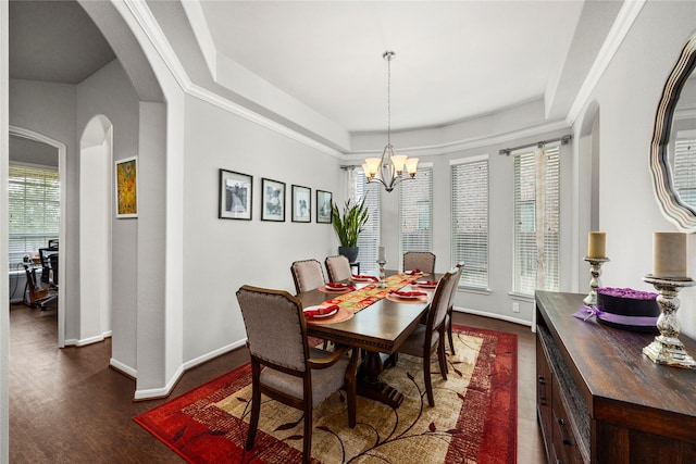 dining area featuring baseboards, arched walkways, a notable chandelier, and dark wood-style flooring