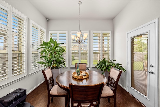 dining room with a notable chandelier, wood finished floors, and baseboards