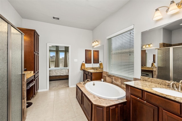 bathroom featuring a sink, tile patterned floors, visible vents, and connected bathroom