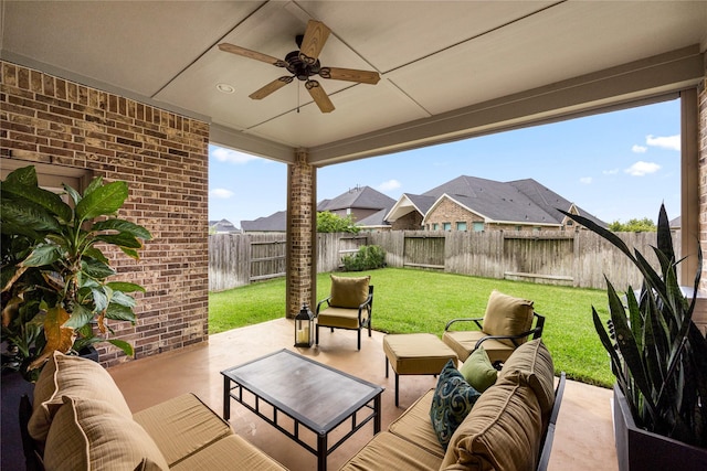 view of patio / terrace featuring ceiling fan, an outdoor living space, and a fenced backyard