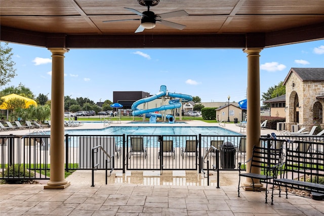 view of patio with a community pool and fence